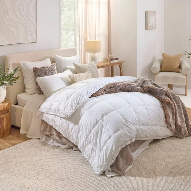 a quilt like this white one with a throw over the top is essential for building your ideal bedroom