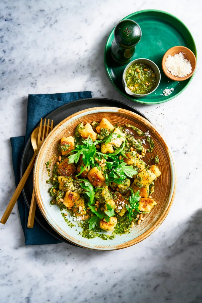 pesto gnocchi with basil pine nuts and rocket on top
