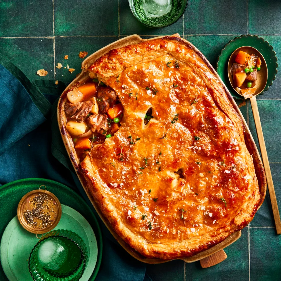 lamb pie with vegetables and one scoop taken out with spoon