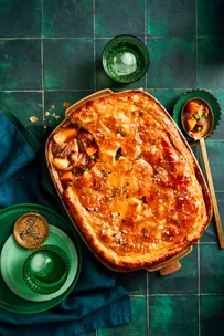 lamb pie with vegetables and one scoop taken out with spoon