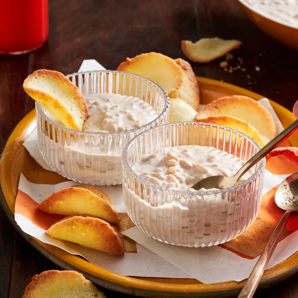 chai rice pudding in glass pudding cups with orange slices decorating it