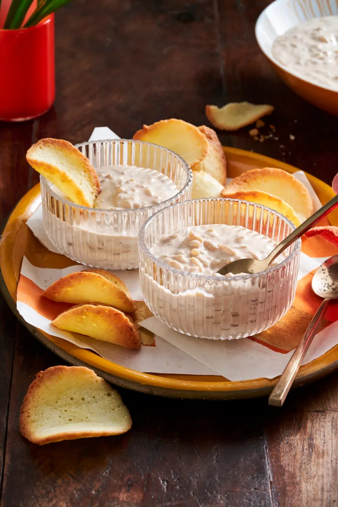 chai rice pudding in glass pudding cups with orange slices decorating it