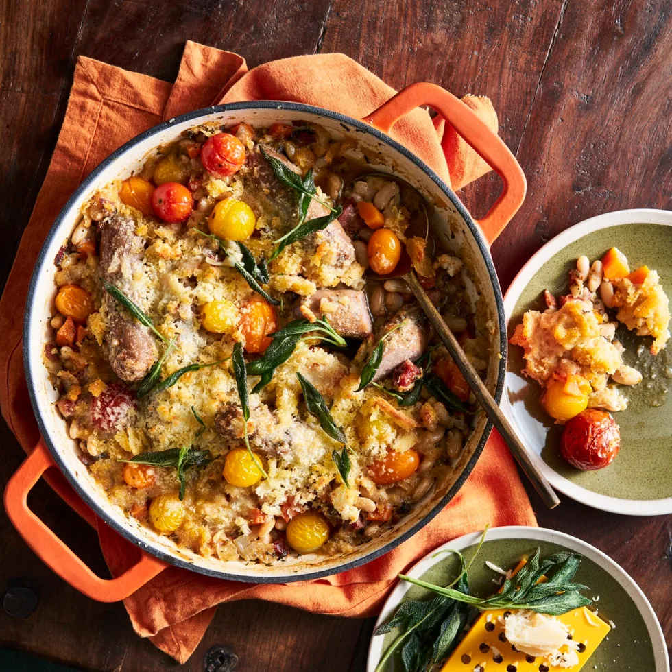 white bean bake in casserole pot with cherry tomatoes and fish