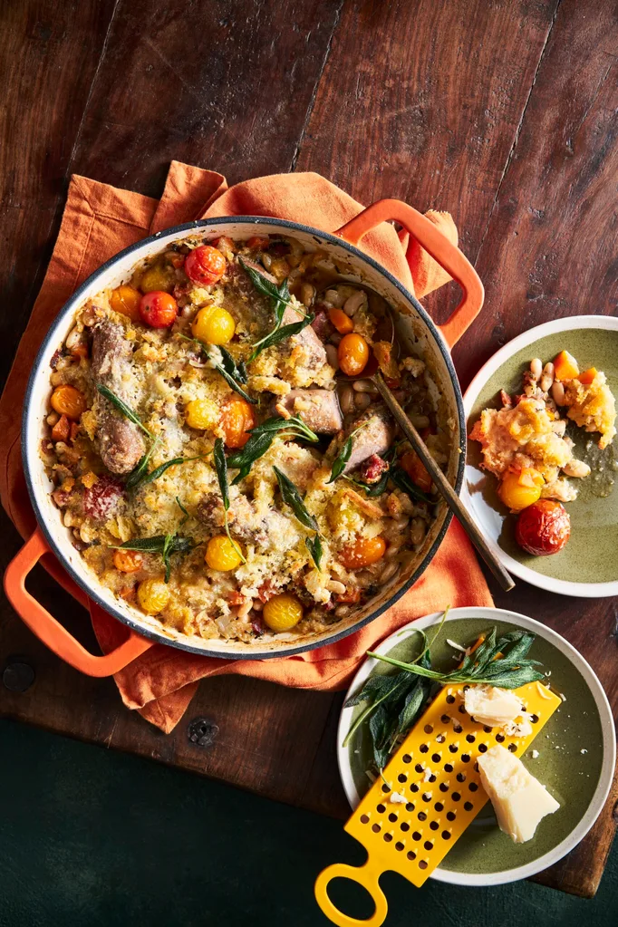 white bean bake in casserole pot with cherry tomatoes and fish
