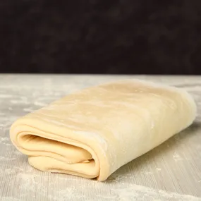 puff pastry rolled into thirds section on floured surface