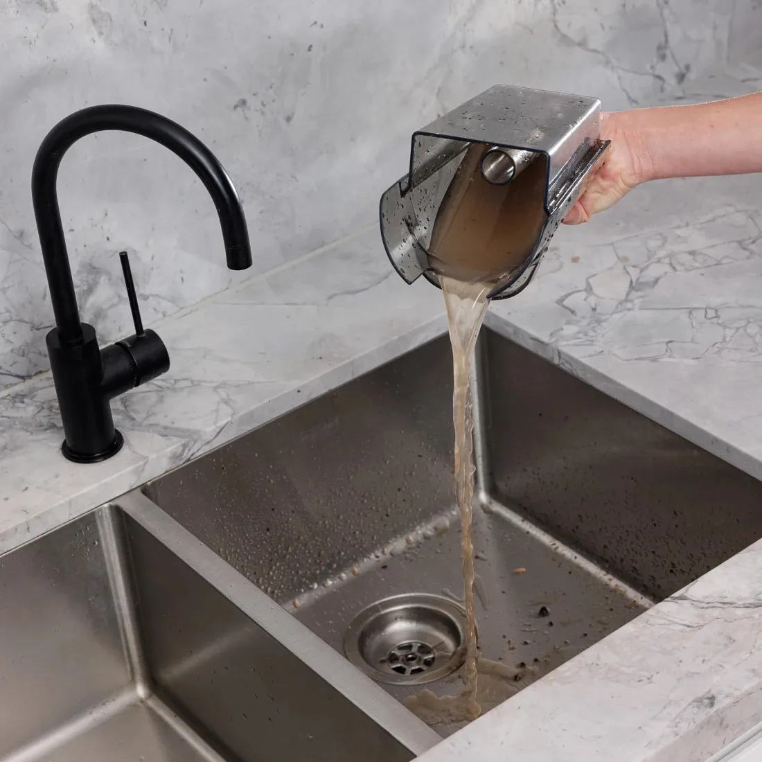 emptying the ryobi floor cleaner dirty bucket into the sink