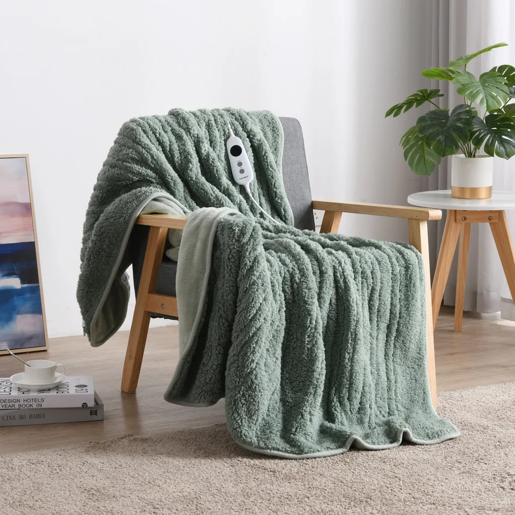 throw blanket heated in sage colour over chair with wooden arms