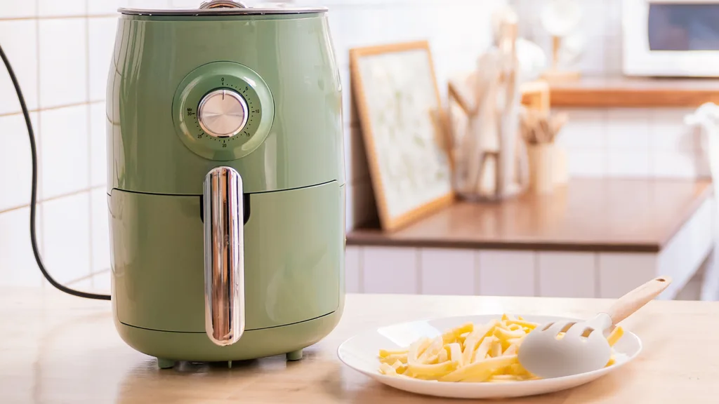 Air fryer on bench with hot chips