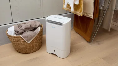 The Ausclimate Cool Seasons Premium 10L Desiccant Dehumidifier in a laundry.
