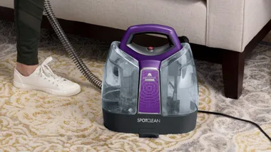 bissel spot cleaner being used on a sofa