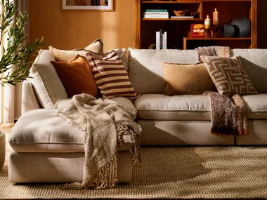 Cosy living room interior featuring warm orange shades