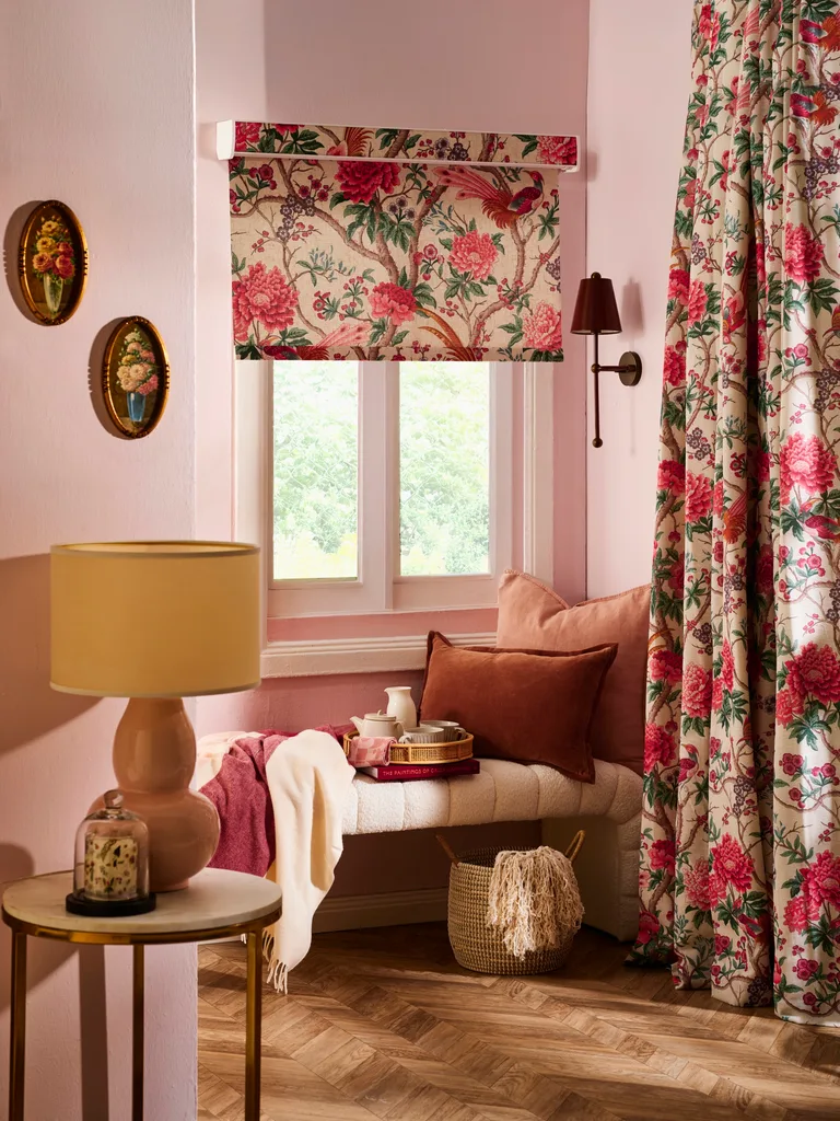 cottage cosy nook ideas with floral fabrics on blinds and curtains and window seat with pink and clay cushions