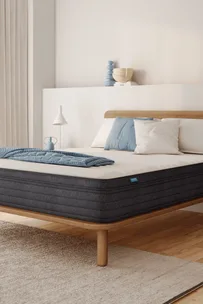 Bedroom with mattress on wooden bed frame, available with Origin Mattress discount code