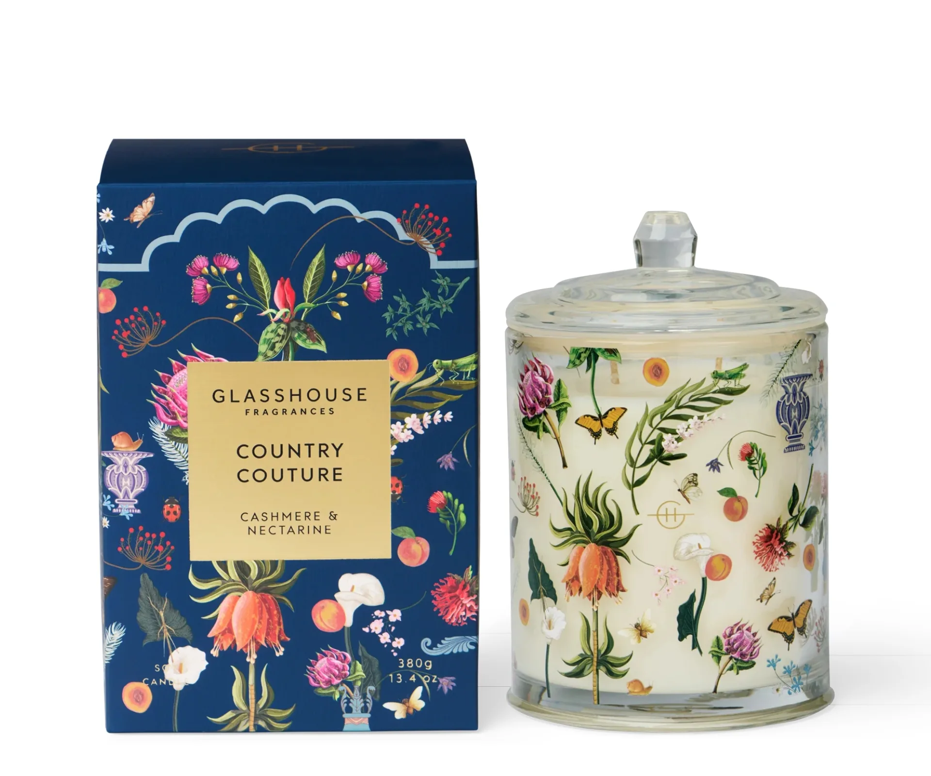 candle set with candle covered in floral design and box next to it