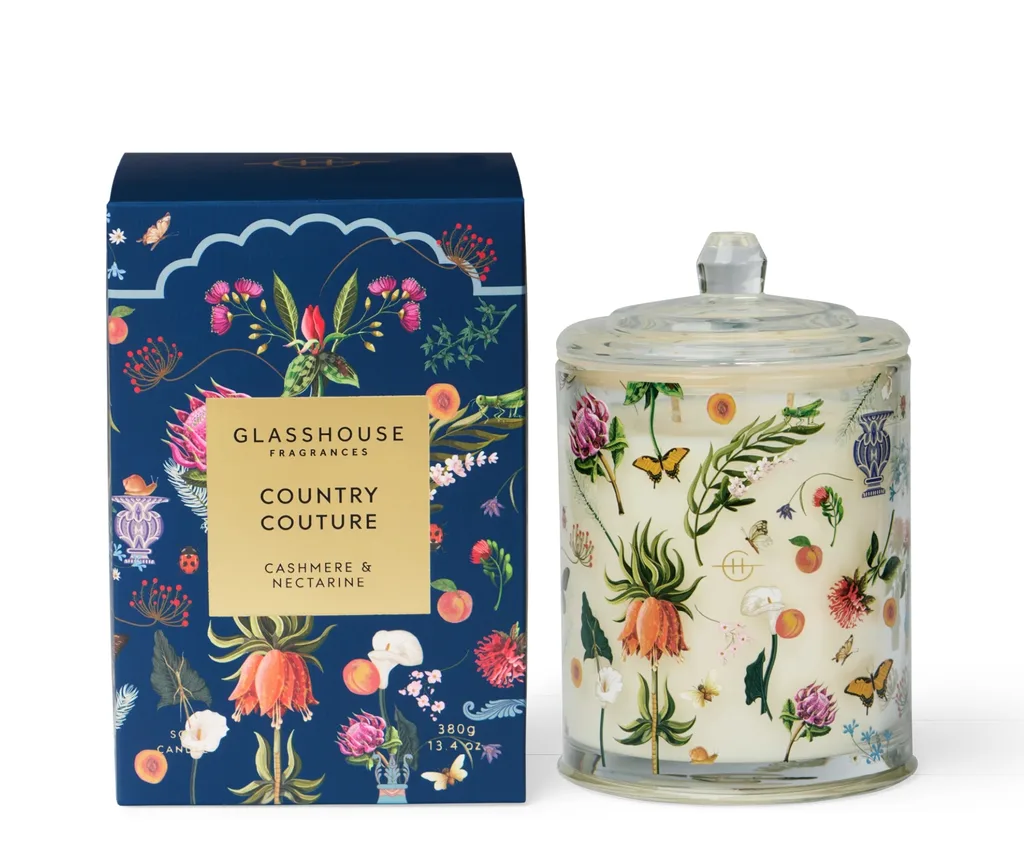 candle set with candle covered in floral design and box next to it