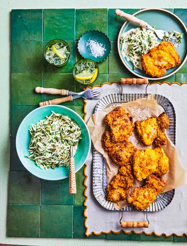 fried chicken on square rounded plate with bowl of slaw on the side