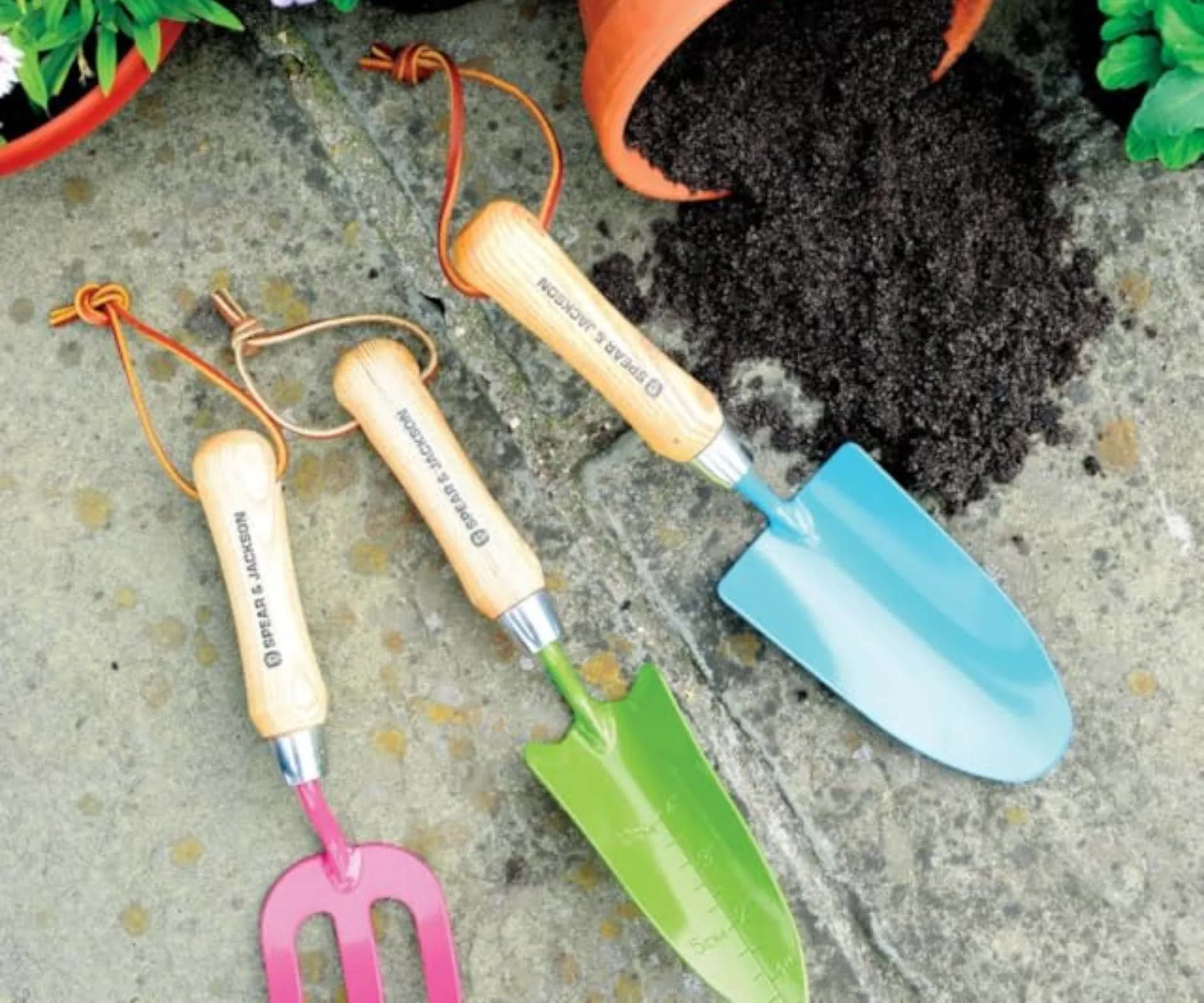 Spear and Jackson garden hand tool set in various colours, including pink, green and blue. 