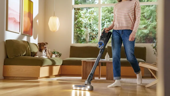 woman cleaning living room with a bissel