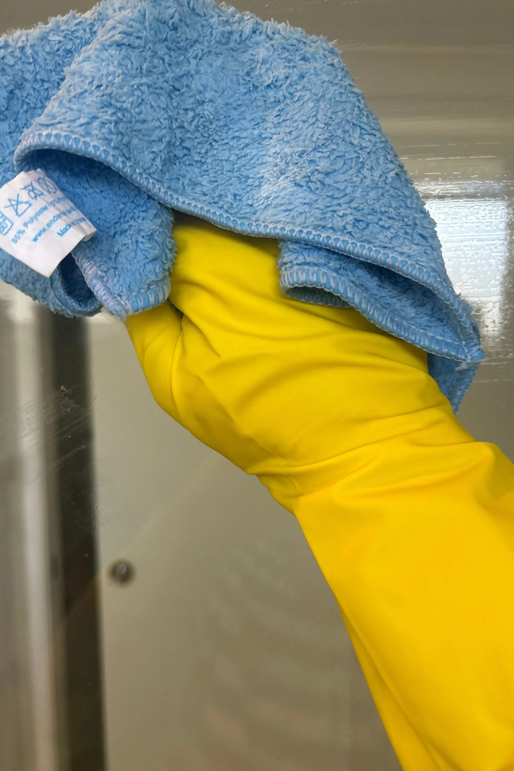 cleaning the shower glass with one shot thick on a soft cloth