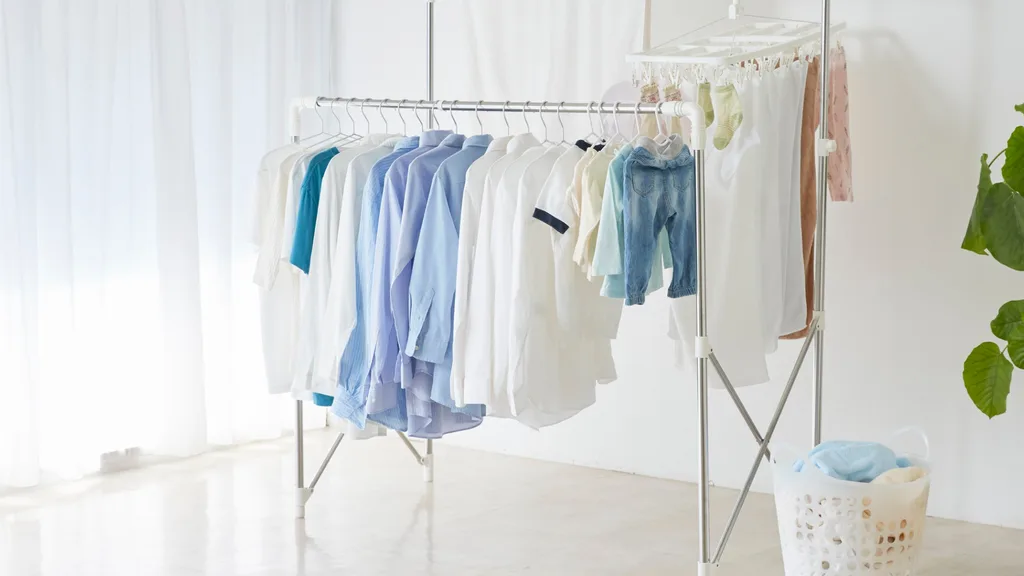 hanging clothes on coathangers to dry