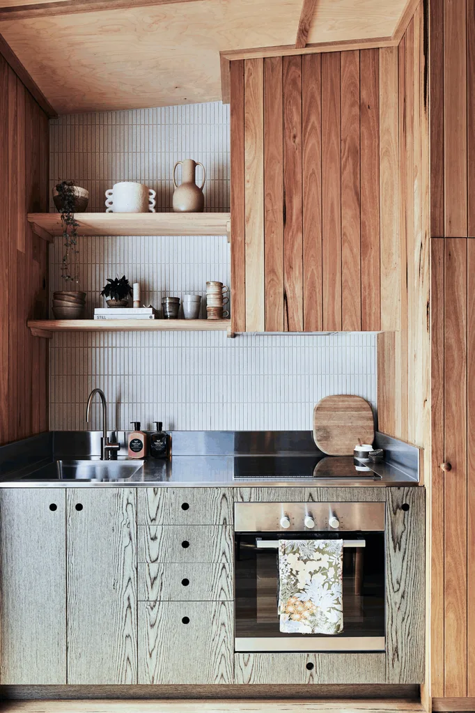 oven in kitchen with wooden cupboards