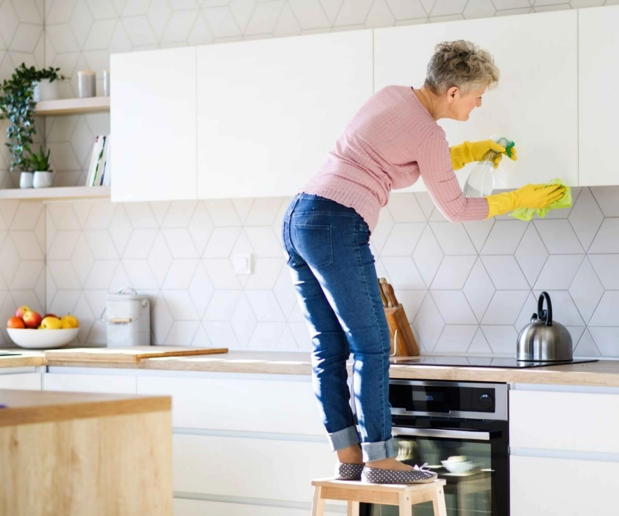 Woman spring cleaning her kitchen