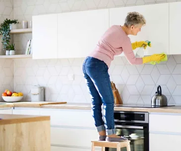 Woman spring cleaning her kitchen