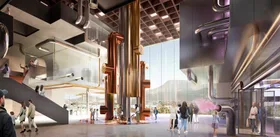 chocolate experience at cadbury with big gold pipes in the middle of the room with children playing and purple carpet