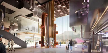 chocolate experience at cadbury with big gold pipes in the middle of the room with children playing and purple carpet