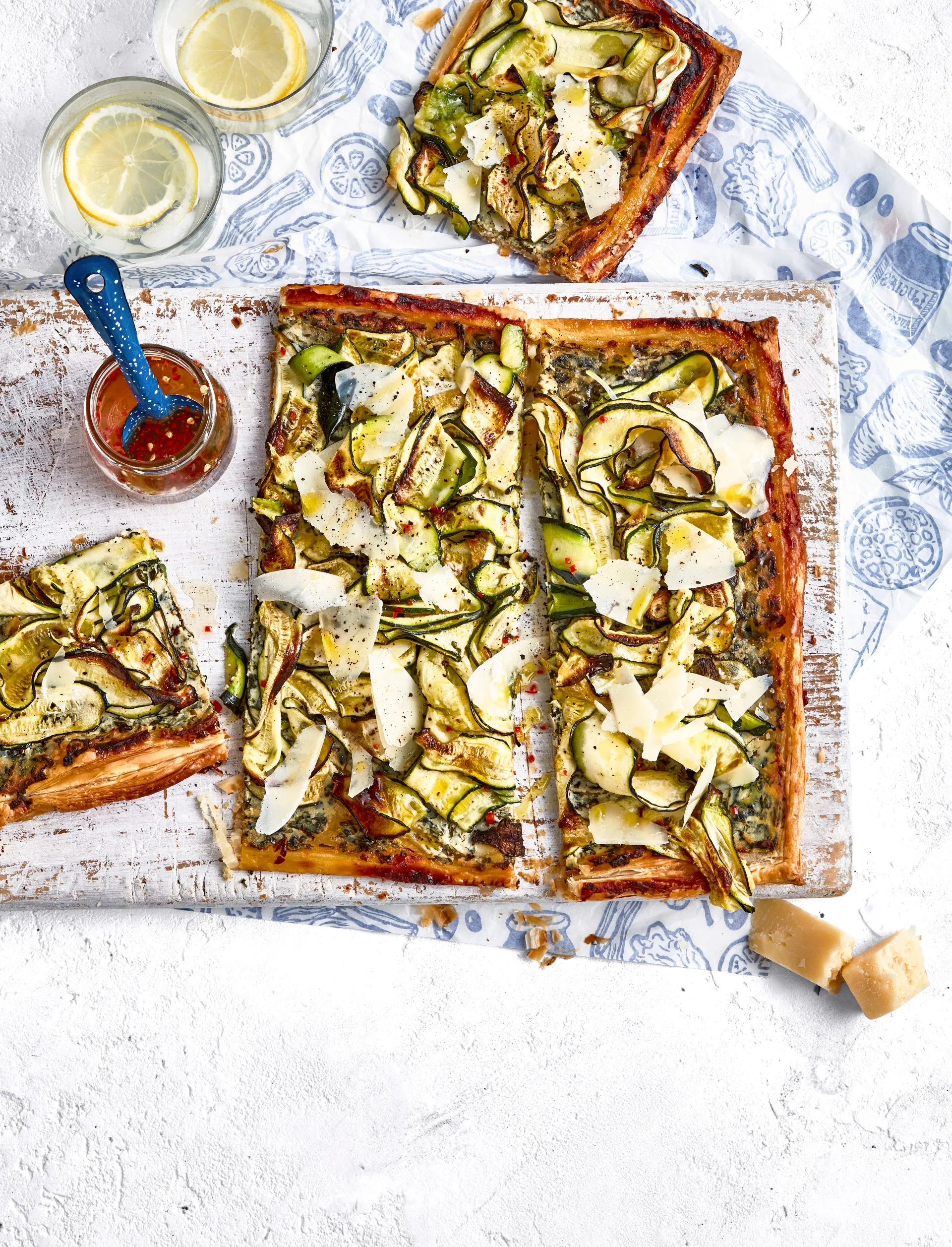 zucchini and ricotta tart on chopping board with extra slice on the side