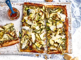 zucchini and ricotta tart on chopping board with extra slice on the side