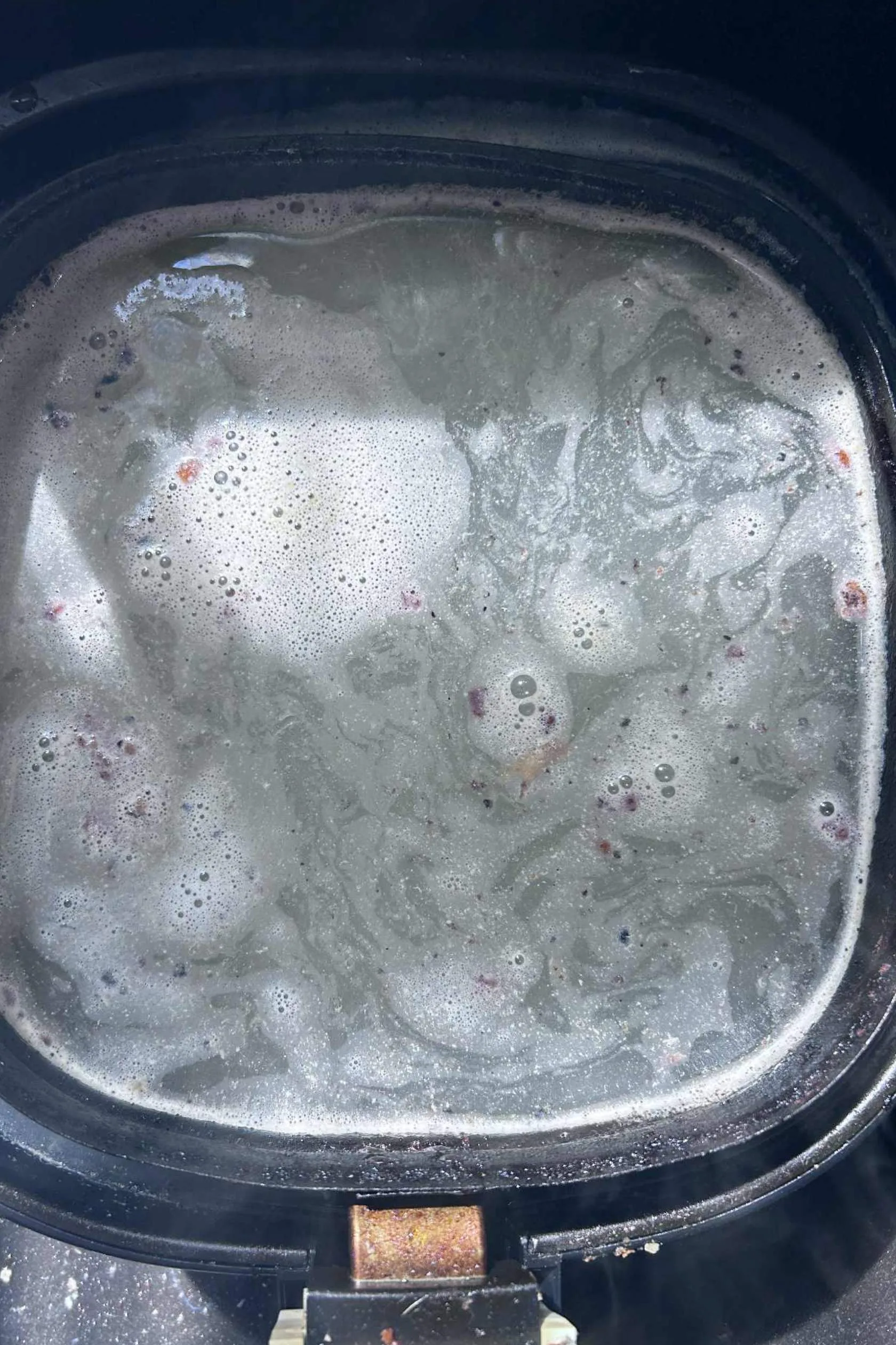 air fryer soaking with a dishwashing tablet
