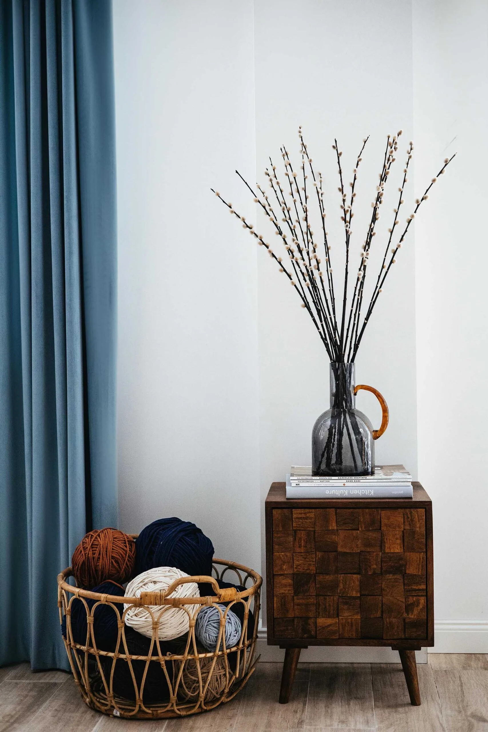 Basket filled with yarn next to a timber side table cabinet