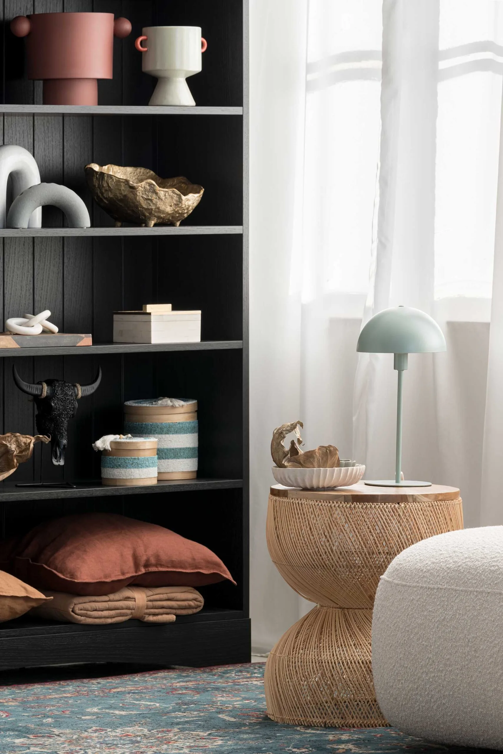 Contemporary sitting area next to a styled bookshelf