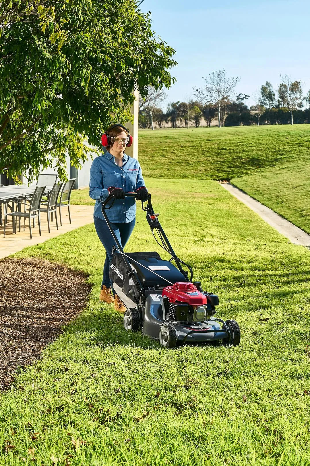 woman mowing lawn