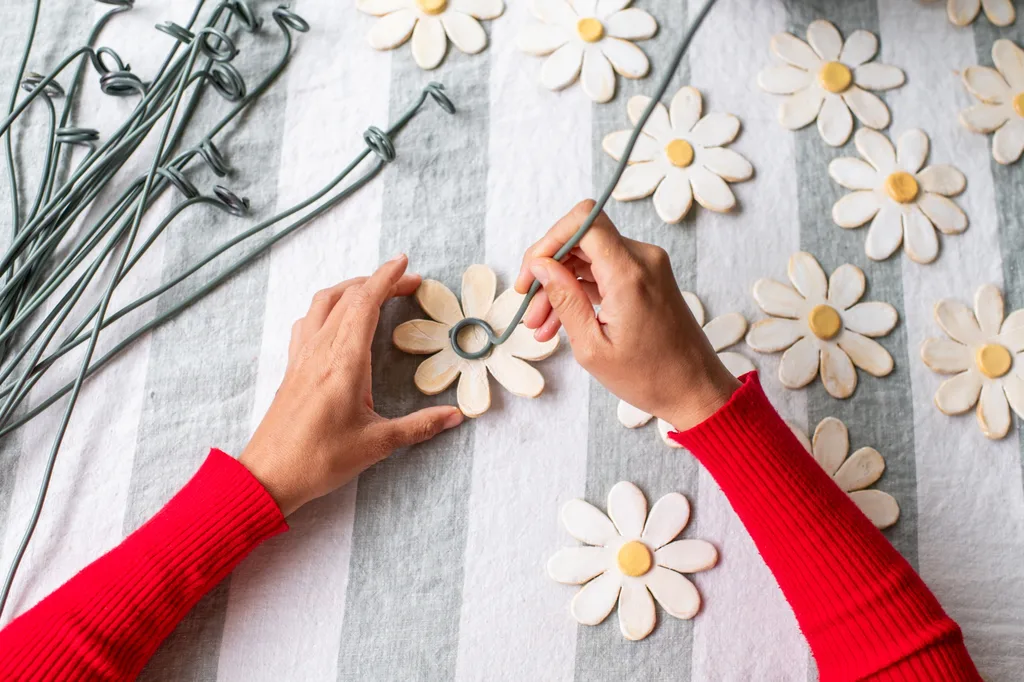 adding wire stems to back of clay flowers