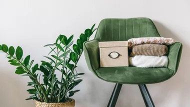 items on green chair waiting to be decluttered