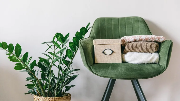 items on green chair waiting to be decluttered