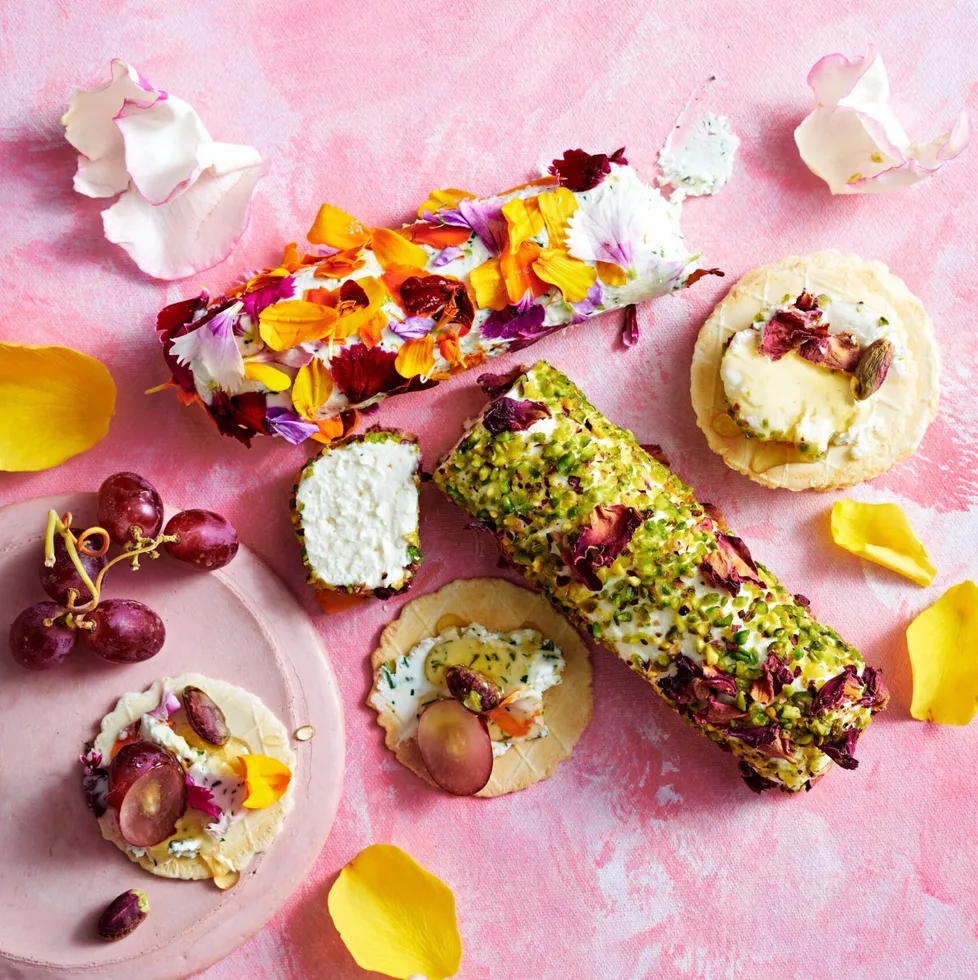 goats cheese logs with edible flowers and pistachios pressed into the outside