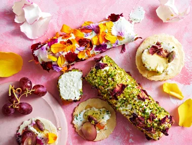 goats cheese logs with edible flowers and pistachios pressed into the outside