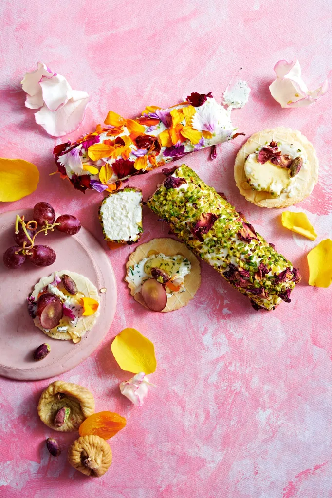 goats cheese logs with edible flowers and pistachios pressed into the outside