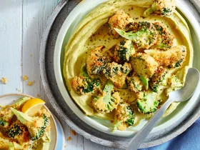 A homemade hummus with crispy broccoli on top.
