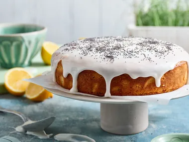 lemon poppy seed cake on white cake stand