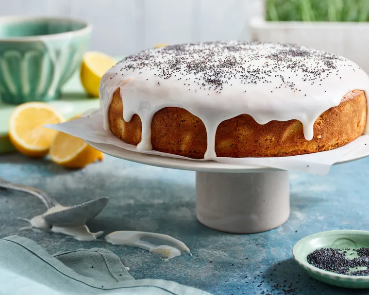 lemon poppy seed cake on white cake stand