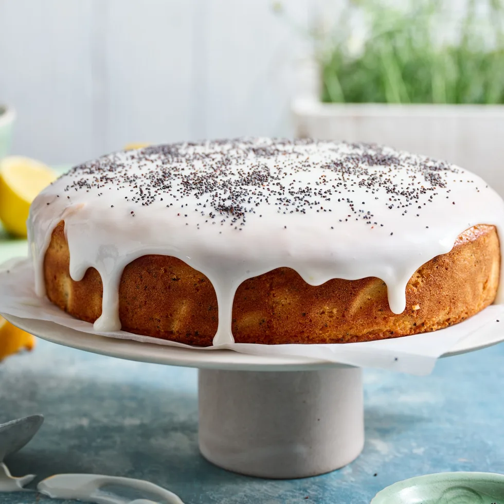 lemon poppy seed cake on white cake stand