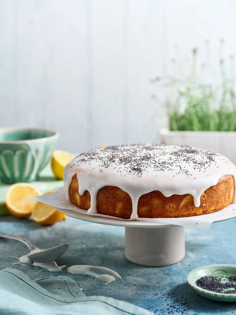 lemon poppy seed cake on white cake stand
