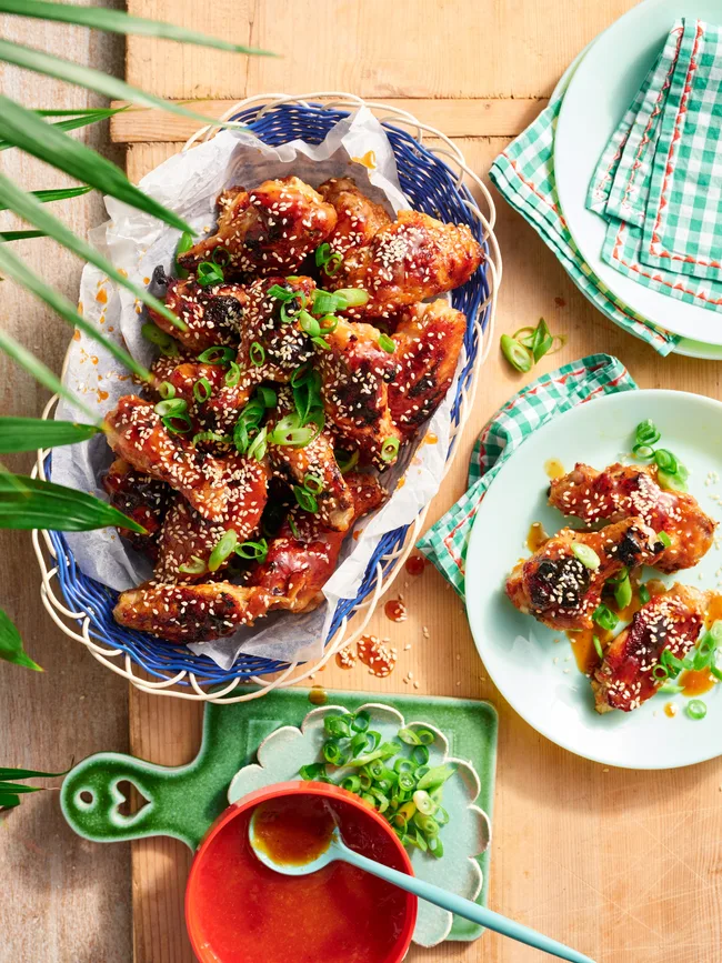 A pile of glazed chicken wings on a plate for a chicken wings recipe.