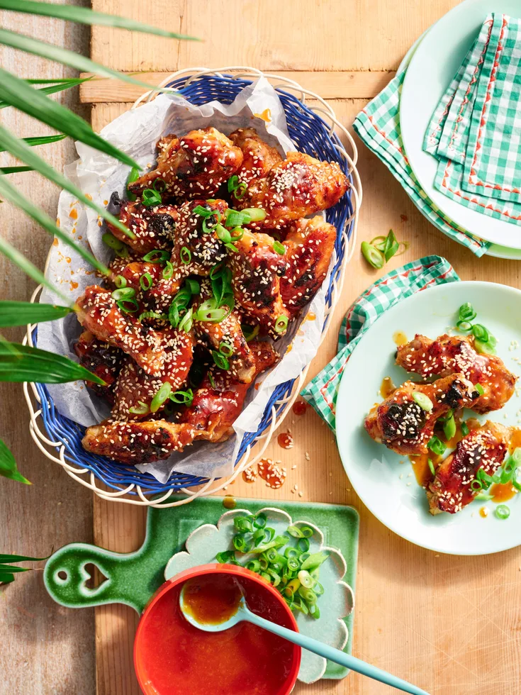 A pile of glazed chicken wings on a plate for a chicken wings recipe.