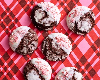 chocolate crinkle cookies with crushed candy cane topping on stripy pink tartan background
