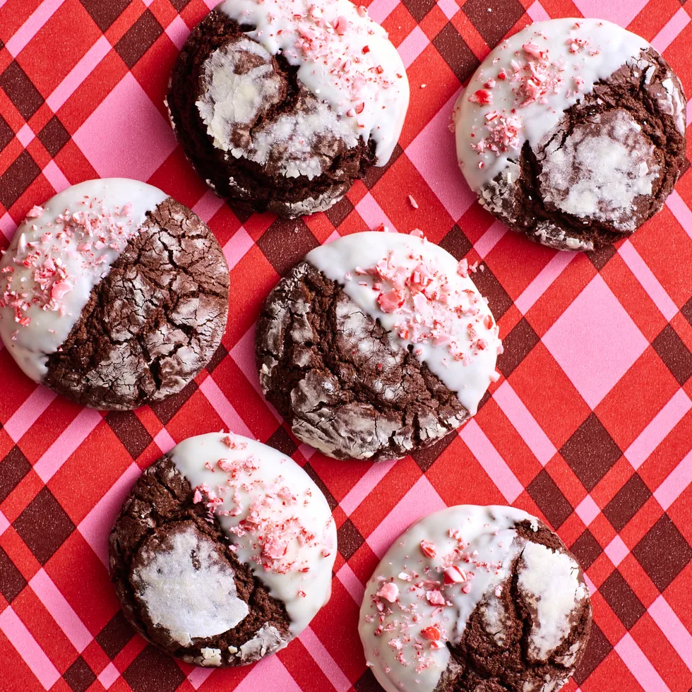 chocolate crinkle cookies with crushed candy cane topping on stripy pink tartan background